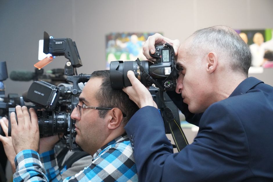 Professional event videographer reviewing footage on set